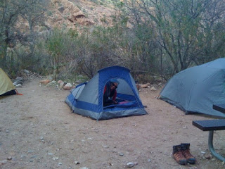 woman smiling in a tent at the bottom of the grand canyon