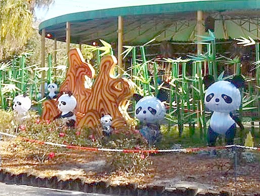 Panda lanterns in front of the carousel at the zoo.