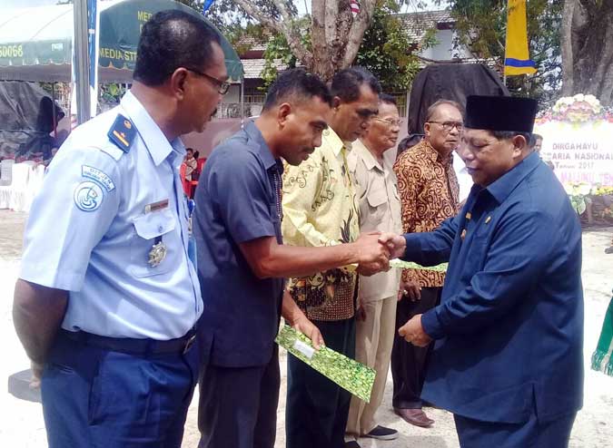 Dua Pegawai Terima Penghargaan Saat Peringatan Hari Agraria Nasional Di Malra Langgur, Malukupost.com - Pelaksanaan Peringatan Hari Agraria Nasional Tahun 2017 di Kabupaten Maluku Tenggara (Malra), Senin (25/9) berlangsung dalam kesederhanaan. Dalam upacara tersebut, dilaksanakan pula penyerahan Sertifikat Program Pendaftaran Tanah Sistematis Lengkap (PTSL) kepada 8 orang penerima Prona, Peserta UKM 100 orang. Selain itu, diberikan juga Penghargaan Satya Lencana kepada Zakarias Moriolkossu sebagai pegawai tertua dengan masa kerja ± 37 tahun yang akan memasuki masa Purna Bhkati pada 1 Oktober 2017 dan Muhammad Agus Hafid Choirudin sebagai pegawai termuda serta pemberian hadiah kepada para pemenang lomba.