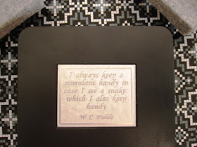 Modern one-twelfth scale miniature table top with W C Fields quote about drinking set into it.