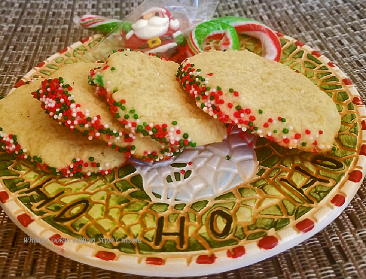 these are almond flavored slice and bake cookies with red green and white sprinkles on them on a Santa plate 