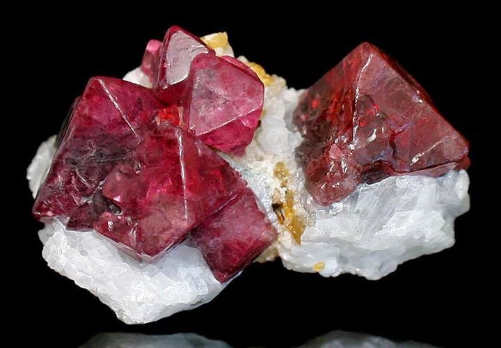 deep red crystals of spinel set atop white marble matrix