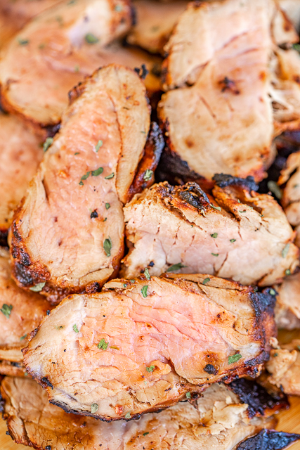 Orange Chipotle Grilled Pork Tenderloin - only 4 ingredients including the pork! So simple and packed FULL of amazing flavor! Pork tenderloin marinated in orange juice, BBQ sauce and chipotle chili powder. Drizzle cooked pork with more BBQ sauce. Great for lunch, dinner and cookouts. SO easy and delicious! #pork #grill #grilling #grilledpork #porktenderloin cooked sliced pork tenderloin