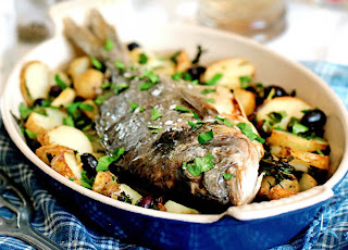 Whole roast bream with potatoes and olives. Whole bream roast on a bed of potatoes and olives.
