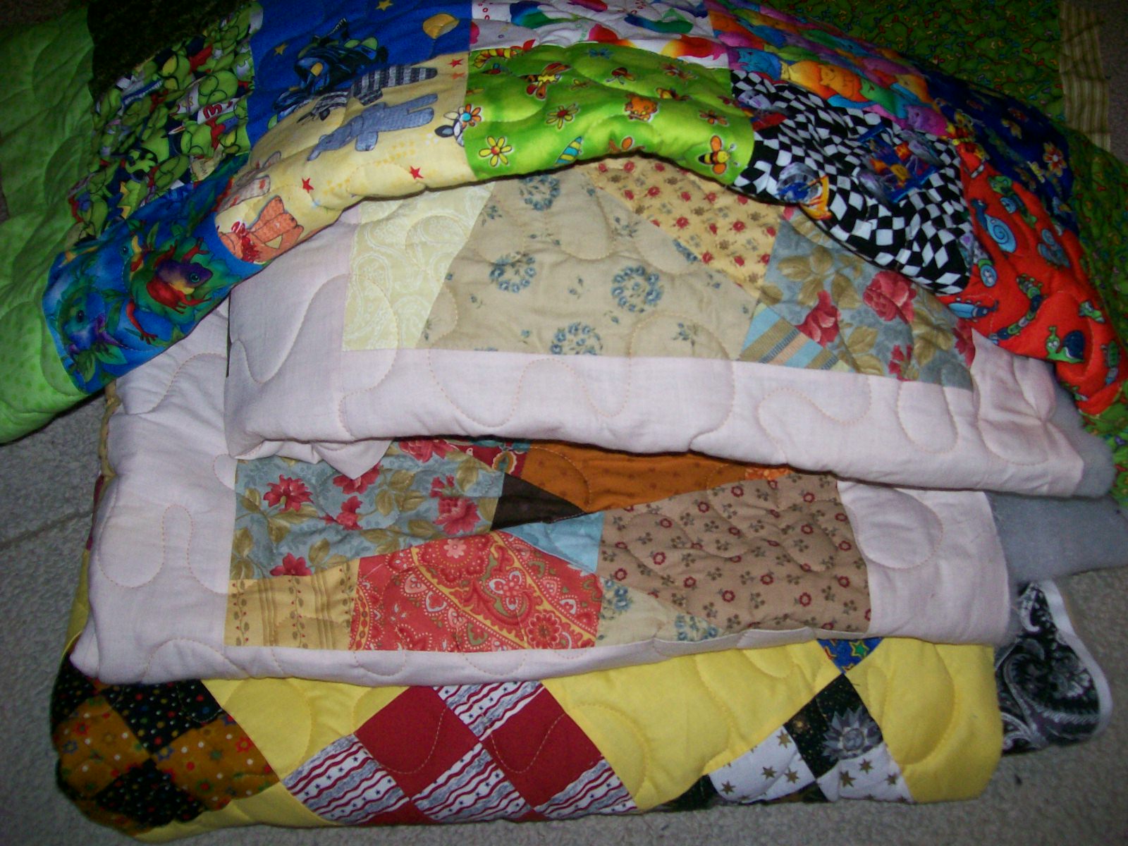 Oz Comfort Quilts. A Pile of Quilts