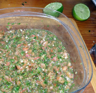 How to Make Salsa:  A tutorial on how to make a quick salsa with tomatoes, onion, cilantro, jalapenos and lime juice chopped fine in a food processor.