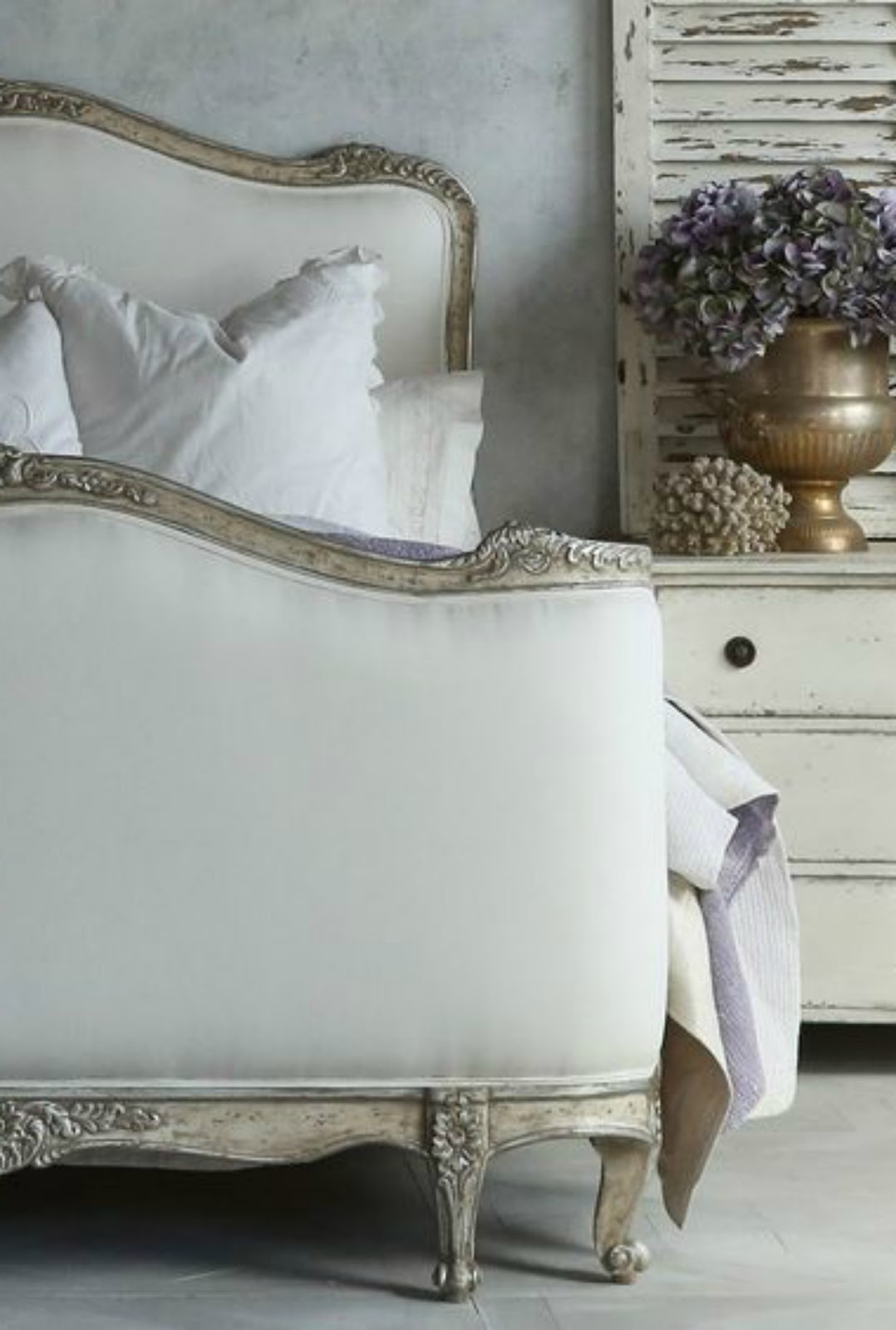 Elegant French farmhouse bedroom with magnificent #frenchcountry bed and weathered shutter. #neutralinterior #romanticdecor #Frenchbedroom