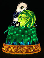 Panda holding bamboo symbolising holding on to peace Pic of huge panda sitting on and holding bamboo