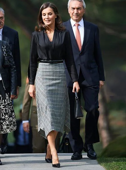 Queen Letizia wore a pointed-check wool skirt by Massimo Dutti and Prada leather pumps and she carried Hugo Boss leather bag