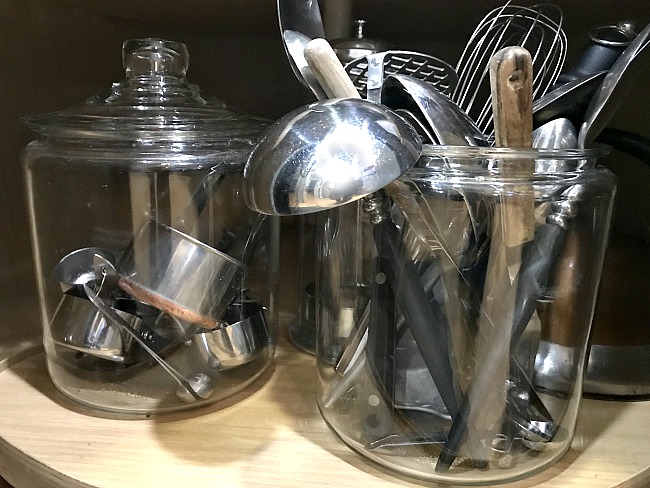 Utensils and measuring cups organized in glass jars