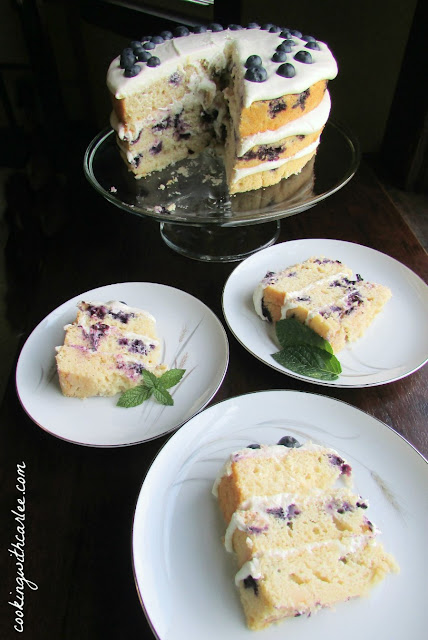 Three layers of luscious lemon cake dotted with blueberries sandwiching cream cheese frosting for an out of this world dessert experience.
