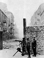 HEAVILY ARMED NAZIS GUARDING ENTRANCE TO WARSAW GHETTO