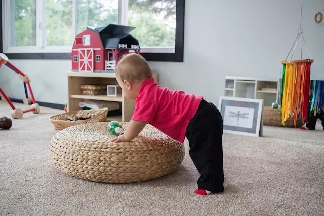 Adding a small footstool to your Montessori baby environment can be an interesting gross motor challenge and the perfect way for a baby to practice pulling up 