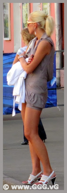 Blonde girl in summer dress on the street