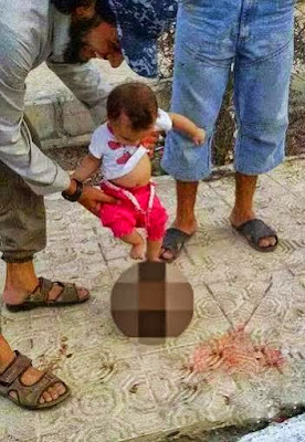 Sick Pic of ISIS Supporter making a baby Kick a severed Head of Syrian soldier!