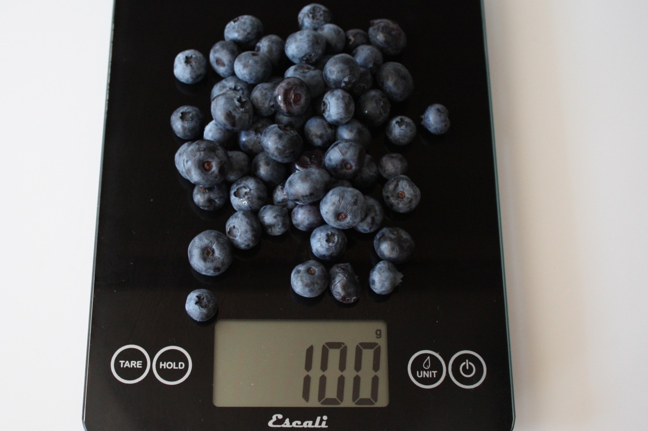 100 grams fresh blueberries shown on digital scale