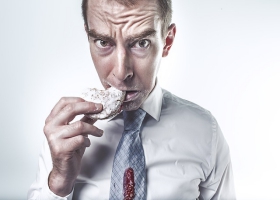 A man eating a cookie. A man eating a cookie.