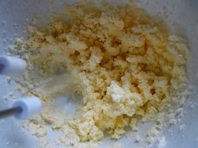 Beat sugar, butter, and cream cheese with a mixer until light and fluffy.