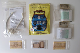 Selection of modern dolls' house miniature kits displayed on a tabletop.