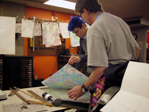 A student peels back a colorful piece of paper