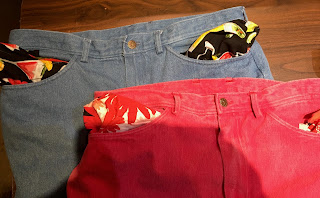 Light blue and red jeans with printed pockets turn out.
