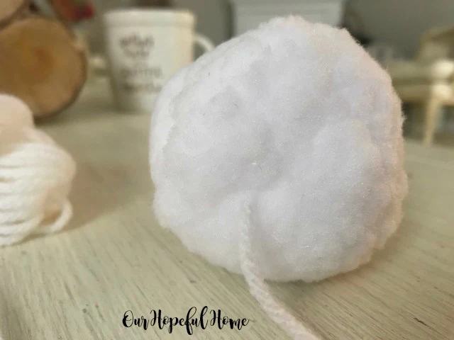 fat round white indoor snowball with yarn