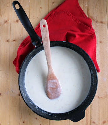 skillet full of beschamel with some Dijon mustard