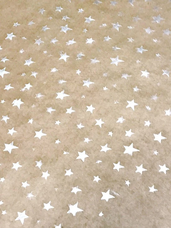 Field of silver stars on gift wrap