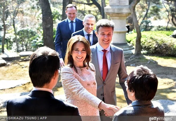 Danish Crown princess Mary and Crown Prince Frederik greet Naoki Ogi professor of pedagogy of Hosei University as they arrive at a traditional Japanese garden to meet young Japanese students and education workers in Tokyo