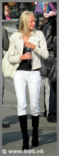 Slim blonde girl in white jeans on the street 