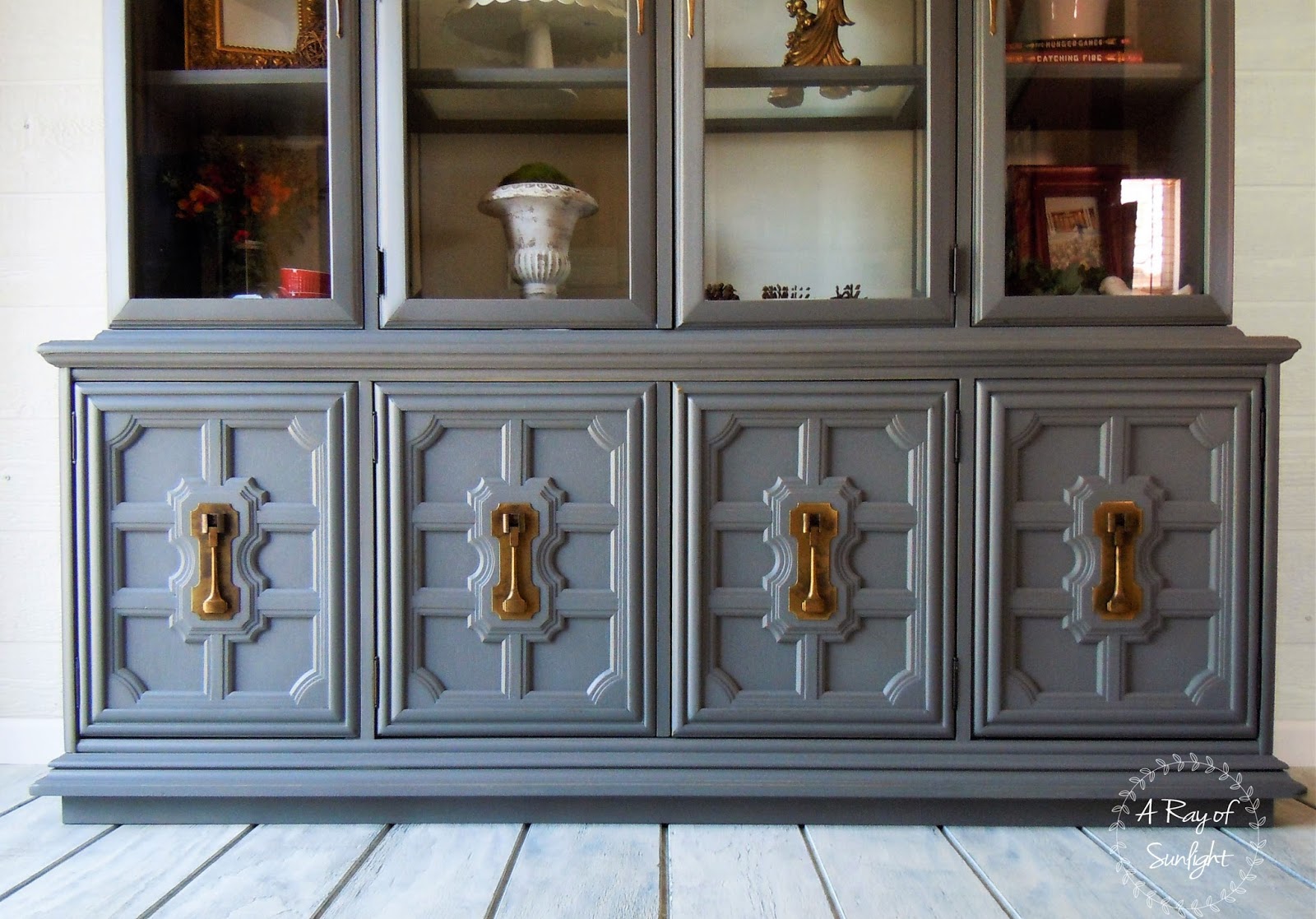 the bottom of the hutch painted gray with cleaned brass hardware