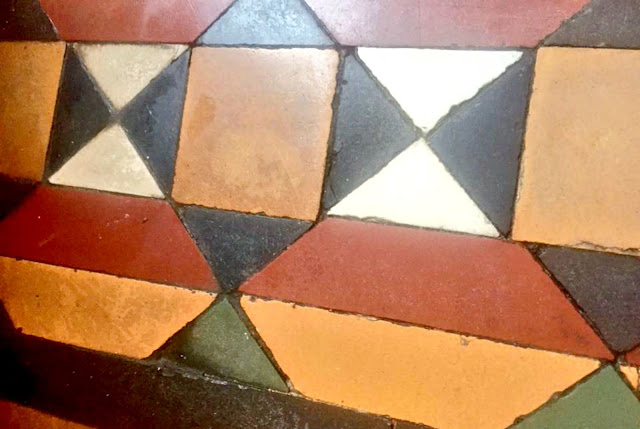 An arrangement of coloured floor tiles