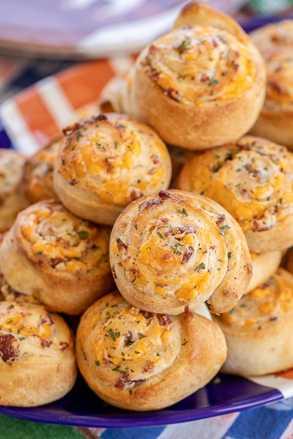 Crack Pinwheels - SO addictive!!! Ranch seasoning, cream cheese, cheddar cheese, and bacon baked in pizza dough - I could eat the whole batch! Great as an appetizer or with soup or stew. Tastes great hot out of the oven or at room temperature. These cheesy bread pinwheels don't last long! #cheddar #bacon #ranch #tailgating #tailgatingrecipes #bread #appetizer Crack Pinwheels - SO addictive!!! Ranch seasoning, cream cheese, cheddar cheese, and bacon baked in pizza dough - I could eat the whole batch! Great as an appetizer or with soup or stew. Tastes great hot out of the oven or at room temperature. These cheesy bread pinwheels don't last long! #cheddar #bacon #ranch #tailgating #tailgatingrecipes #bread #appetizer