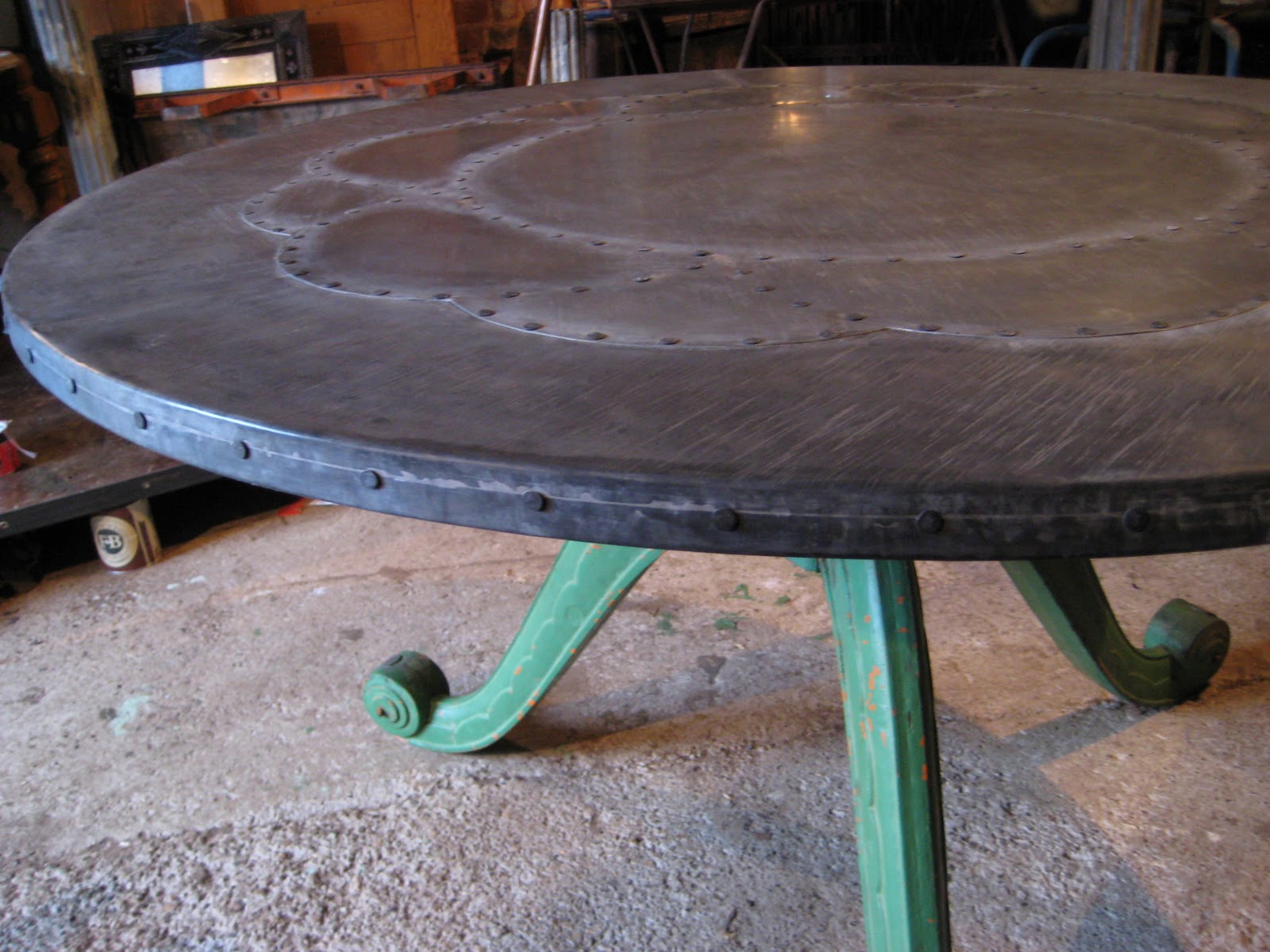 Deballage Designs Circular table with a zinc top with a studded