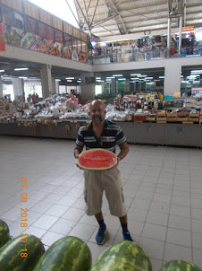 Holding a half piece of one of the largest watermellons seen in my lifetime to date.