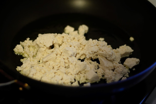 The scrambled tofu in the frying pan. 