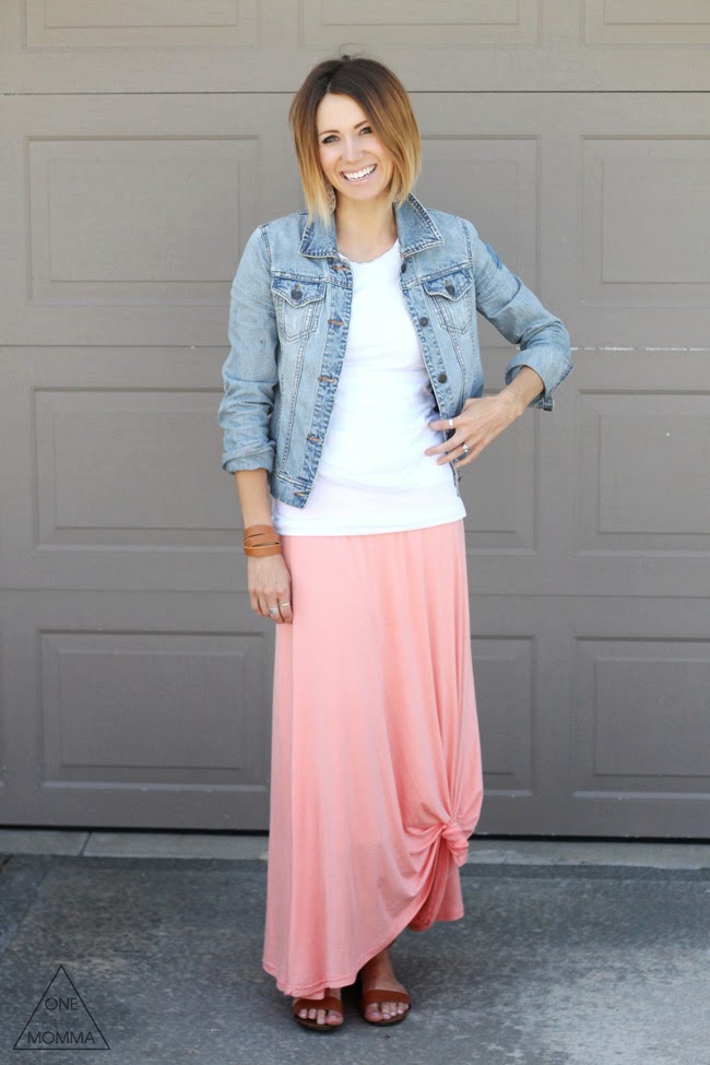 Denim jacket, white tee, and a  peach maxi skirt tied up in a knot.