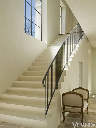 Pamela Pierce interior designed French country Houston home with plaster steps and French iron railing - architecture by Reagan Andre. #frenchcountry #interiordesign #staircase #frenchhome