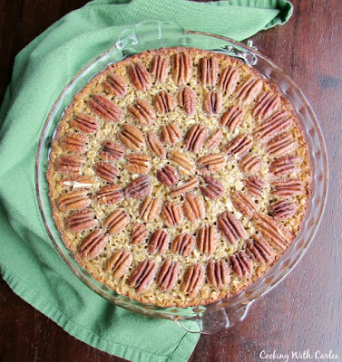 Pecan pie is now an acceptable breakfast! This pecan pie inspired baked oatmeal is delicious, nutritious and hearty! pan of pecan pie baked oatmeal with whole pecans arranged in circles over the top
