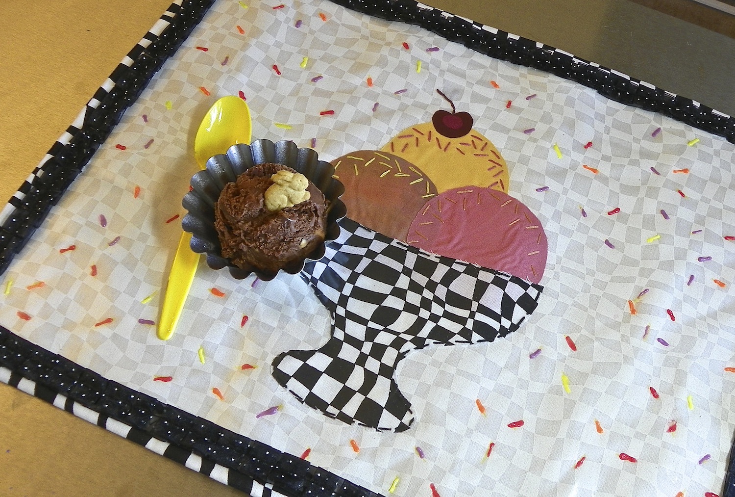 Embroidered fabric and vinyl placemat