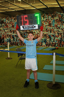 With the Score Board Young fan holding the score board at Manchester City