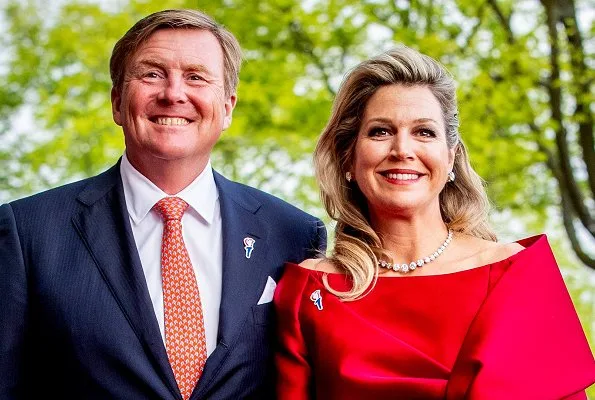 Queen Maxima wore a red top and red trousers. by Natan.Sarah's clutch bag. Carré Royal Theatre and around Amstel River