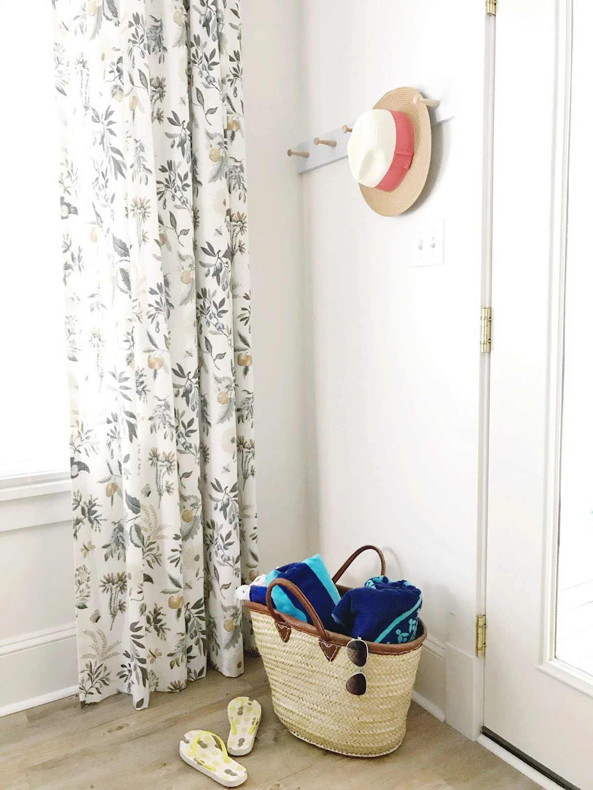 diy shaker peg rail, straw hat, country floral curtains, beach bag