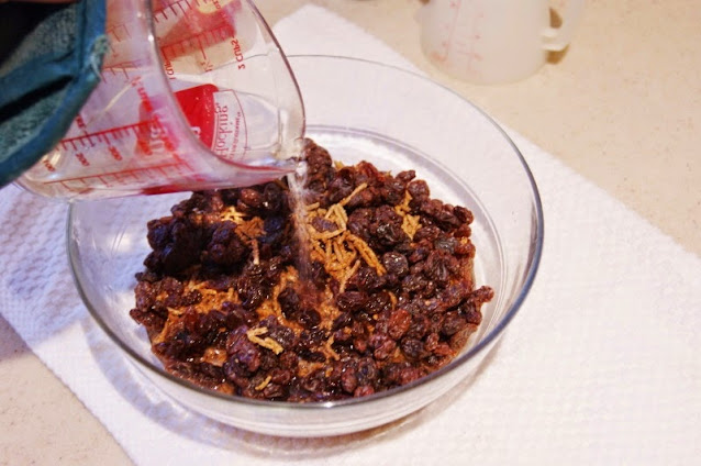 Pouring Boiling Water Over All Bran and Raisins to Make Refrigerator Bran Muffins Image