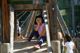 Chinese girl in wooden playground framework