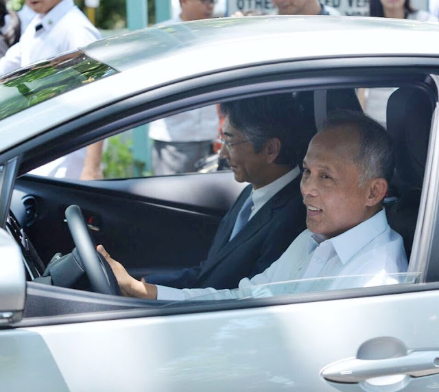 The Japanese government, through its Non-Project Grant Aid, has funded the purchase of P250-Million worth of Toyota Prius Hybrid cars. They did this to support the Philippine Government, specifically the Department of Energy's campaign to promote energy efficiency and clean air across the country. The DOE will distribute the cars to replace some service vehicles of national government offices with hybrid cars. Officials of the Energy Utilization Management Bureau and Japan’s Ambassador to the Philippines, Kazuhide Ishikawa, turned over the hybrid Toyotas to the beneficiaries last Friday at the DOE Sunken Garden in Taguig.  The Non-Project Grant Aid (NPGA) is part of the Japan International Cooperation System. A hybrid car is called such because it is powered two different ways. It has an optimized fuel engine while also having an electric motor to provide another means of moving the vehicle. Using a computer, the car can move by either mechanism or both at the same time, depending on the driving conditions. The electric motor is usually for slow speed. The fuel engine comes in when more power is needed. Also, when the car is on a downhill road, or when the car is cruising, the batteries are actually being charged by the electric motor. This increases the efficiency of the car. In uphill climbs, the motor assists the fuel engine so that less fuel is also used. This is how hybrid vehicles attain the highest energy efficiency. The best part is that hybrid cars have lower carbon emission, making it more environmentally friendly. The beneficiaries of the hybrid cars include the Office of the President, Department of the Interior and Local Government (DILG), Department of Finance (DOF), Department of Foreign Affairs (DFA), Department of Budget and Management (DBM), Department of Transportation, Department of Tourism (DOT), Department of Trade and Industries (DTI), Department of Environment and Natural Resources (DENR), National Economic Development Authority, Department of Science and Technology (DOST) and the Philippine National Police. Eight hybrid cars will also be given to government offices in Region 8, including the DENR, DTI, DOST, Bureau of Fire Protection, Philippine Information Agency, Land Transportation Office and the Regional Disaster Risk Reduction and Management Council. They were given priority to support the recovery of the local government and the many communities devastated by Super Typhoon Yolanda in 2013. “This Japan government-aided grant will jump-start our drive towards our call to action to our fellow public servants to increase their use or patronize energy efficient technologies, including their official vehicles. We have to be the role model in this cause, so our people can look up to us and follow our lead,” Energy Secretary Alfonso Cusi said. In the Philippines, a compact version of Prius is available, the Prius C. Toyota Philippines website quotes the price of the standard model at P1,639,000. The full options sells for P1,689,000.