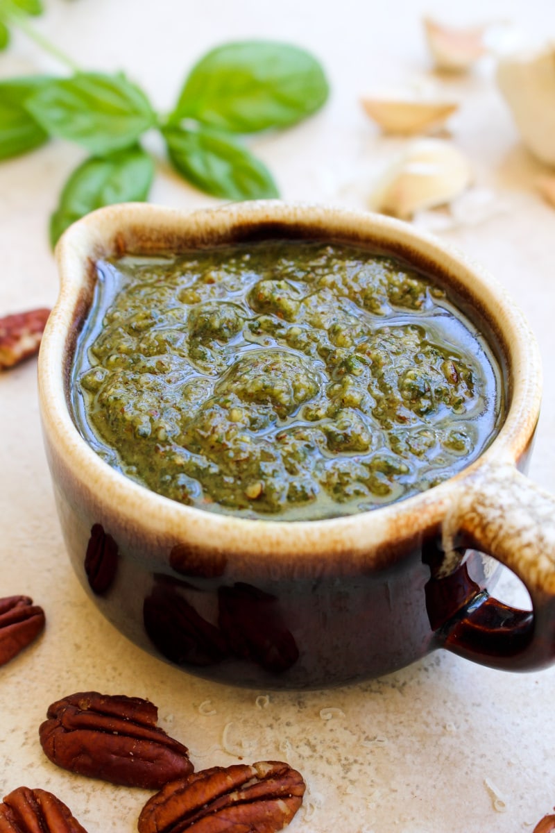 Pecan Basil Pesto is a twist on traditional pesto that uses pecans instead of pine nuts. It is super versatile and can be used in so many ways!  #pesto #pecans