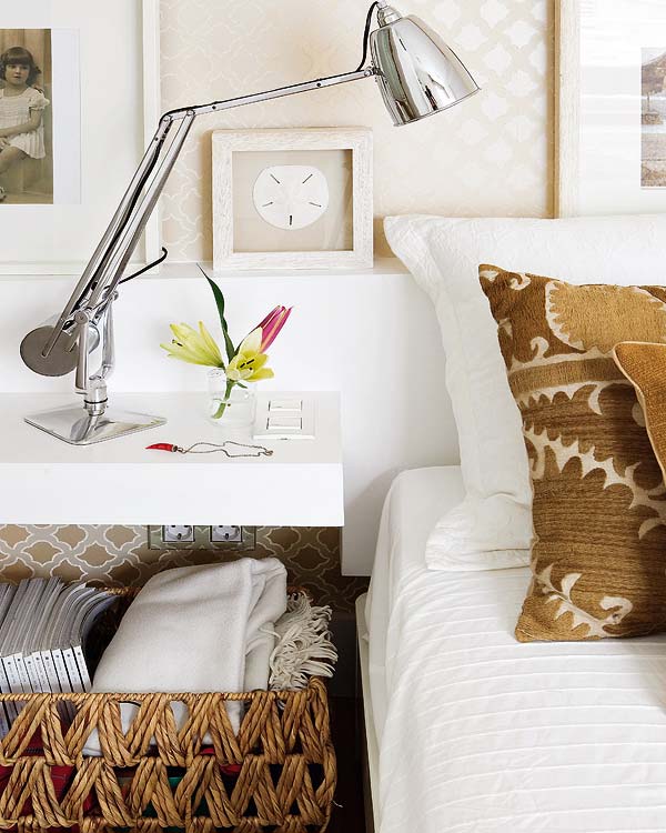 Close up of the white floating nightstand with a wicker basket underneath for more storage