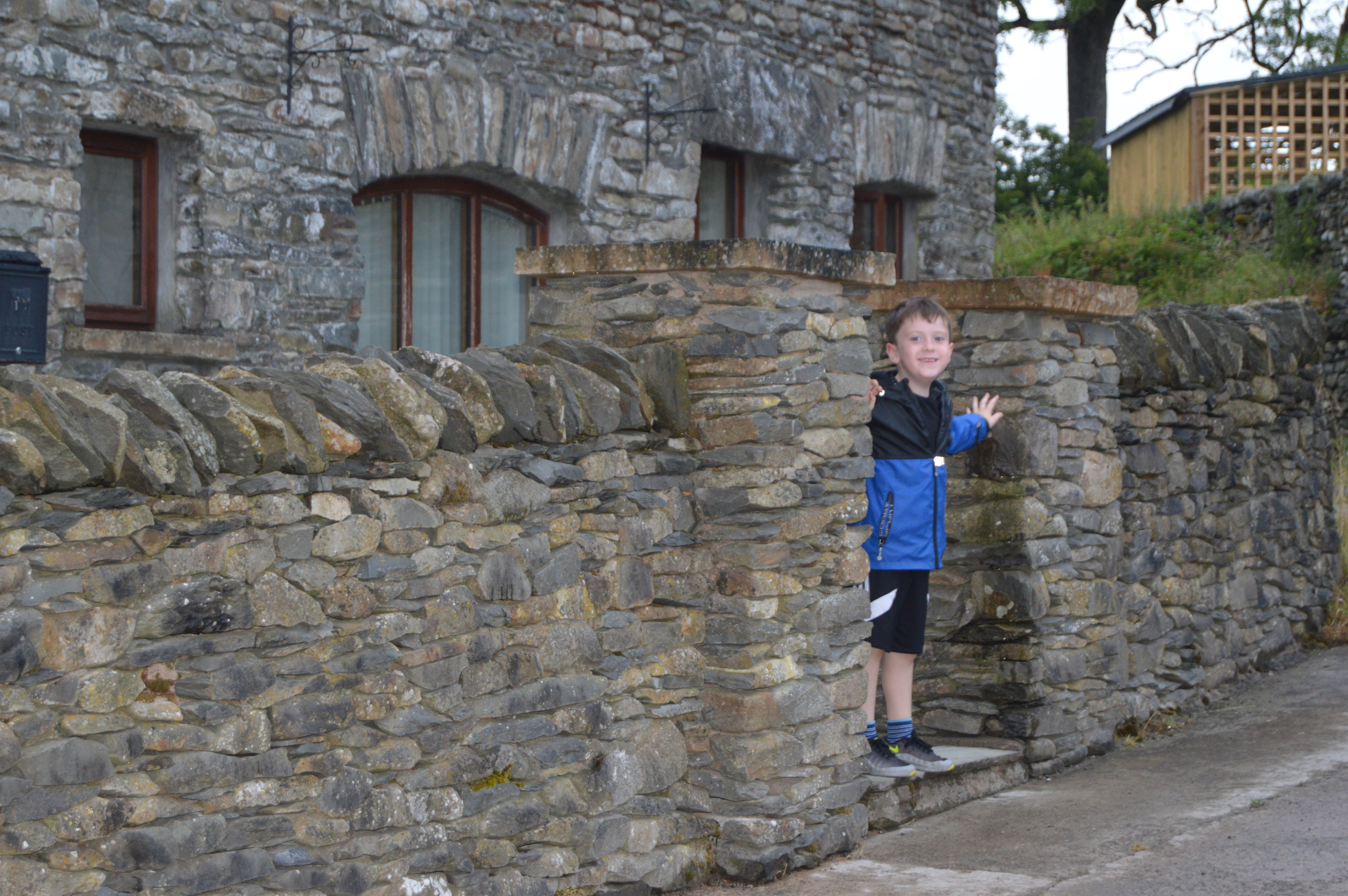 Boy standing outside Simgill Cottage