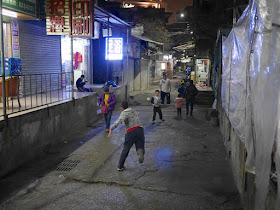two boys and a man playing Gongbei-ball in Zhuhai